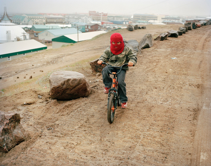 A kid on a bike, Iqaluit. From the serie "A Woman With Two Names", Vittoria Mentasti.